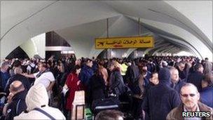 People waiting to be evacuated at the check-in hall at Tripoli airport