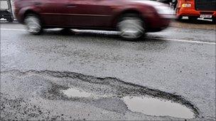 Car drives past pothole in Bristol