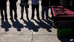 Baja California state police display to the media 14 suspected members of the Sinaloa cartel