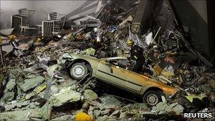 Rescue workers search through the rubble of Canterbury TV/King's Education building in Christchurch, New Zealand (23 Feb 2011)