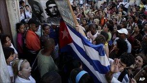 Supporters of Cuba's government chant revolutionary slogans as they argue with members of the Cuban dissident group Ladies in White