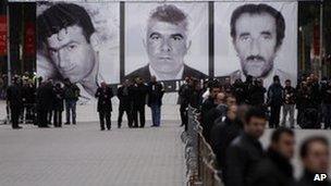 Albanian protesters gather under pictures of those killed in the Tirana unrest, 28 January