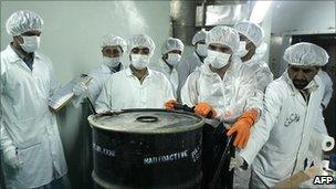 Iranian scientists with a sealed container of radioactive uranium, Isfahan (Aug 2005)