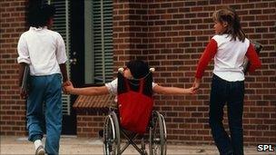 Girl in wheelchair with other children