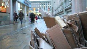 cardboard waste stacked on a street