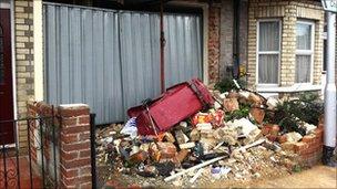 The boarded up house after it was hit by a car