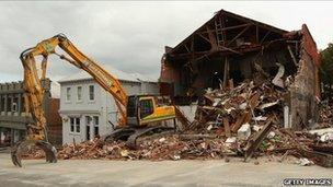 An earth mover is parked in a street to demolish a collapsed building in Lyttelton on 26 February 2011 in Christchurch, New Zealand.