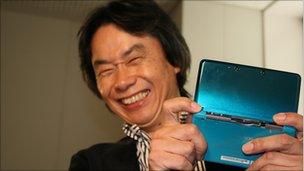 Shigeru Miyamoto holds up the Nintendo 3DS