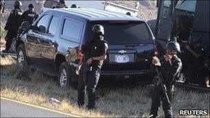 A US Immigration and Customs Enforcement vehicle is seen next to Mexican federal police officers near San Luis Potosi, 15 February 2011