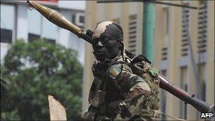 An Ivory Coast's soldier stands guard in Abidjan - February 2011