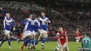 Obafemi Martins and Birmingham celebrate after an Arsenal mix-up