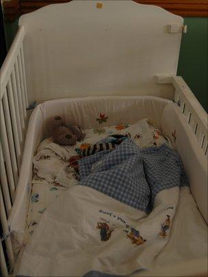 A baby sleeps inside a cot at the Door of Hope orphanage