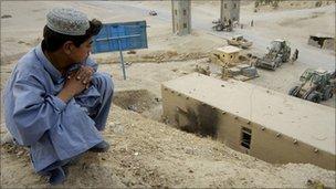 Afghan boy watching construction