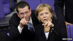 Karl-Theodor zu Guttenberg with Chancellor Angela Merkel in the Bundestag (Oct 2009)