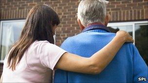 Elderly man being helped to his door