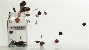 Money falling in jar