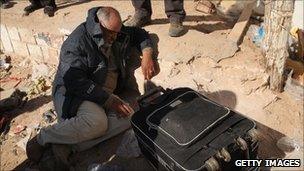 An exhausted man rests after entering Tunisia from Libya on March 1, 2011 in Ras Jdir, Tunisia.