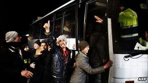 Illegal migrants are put on a coach in Lampedusa, 2 March