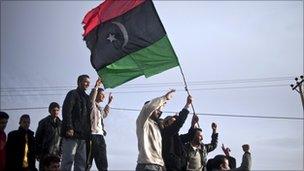 Libyan anti-government protesters wave an old Libyan flag in Zintan
