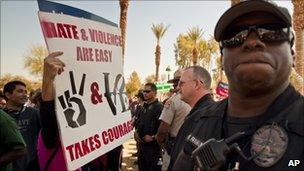 An immigrants" rights supporter protests in front of the Capitol Police at the State Capitol in Phoenix