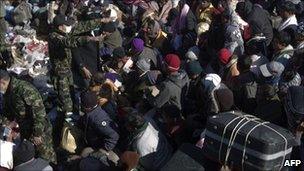 People waiting on Libyan soil to cross into Tunisia