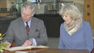 Prince Charles and Camilla, The Duchess of Cornwall sign the visitors book at GCHQ