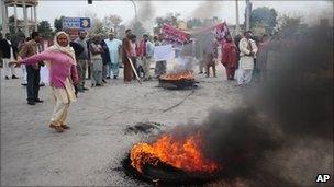 People from Pakistan's Christian community burn tyres in protest against the killing of Shahbaz Bhatti in Islamabad, Pakistan: 3 March, 2011.