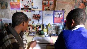 Schoolgirls working inside their accommodation, known as a ghetto, in rural Tanzania