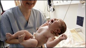 Midwife with newborn baby