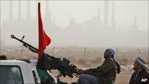 Anti-Gaddafi fighters man a heavy machine gun mounted on a pick-up truck in Ras Lanuf, 5 March.