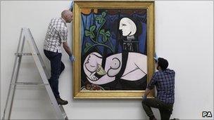 The painting being hung up at Tate Modern