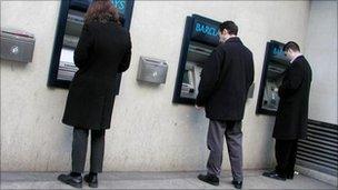 People at cash machines