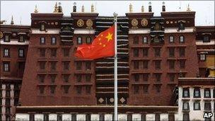 A Chinese flag flies over the square near the Potala Palace in Lhasa