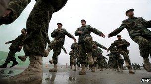 Afghan National Army (ANA) non commissioned officers (NCO) march during a graduation ceremony in Kabul on February 3, 2011.