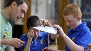 Children with a teacher at a science festival