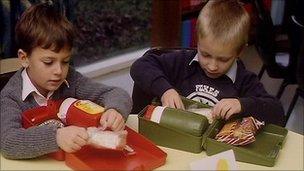 Primary school children eating packed lunch