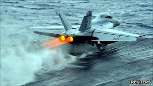 An F/A-18F Super Hornet launches during operations aboard the aircraft carrier USS Enterprise in the Red Sea (US Navy handout photo), 7 March 2011