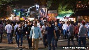 Crowds walking in and out of music venues on 6th Street in Austin