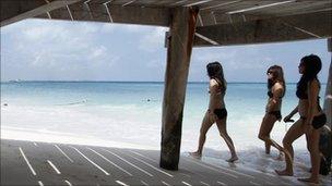 Women in bikinis on beach in Cancun