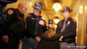 Police remove a protester from the state capitol