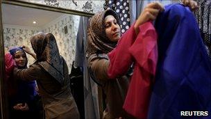 A woman tries on Islamic clothing at a shop in Grozny, Chechnya, 9 March 2011