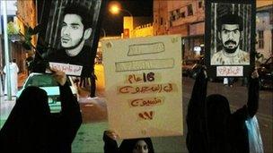 Protesters hold posters of prisoners during a demonstration in Qatif, Saudi Arabia (9 March, 2011)