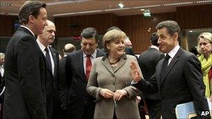 From left, British Prime Minister David Cameron, Greek Prime Minister George Papandreou, European Commission President Jose Manuel Barroso, German Chancellor Angela Merkel and French President Nicolas Sarkozy share a word at an EU Summit in Brussels on 11 March 2011