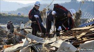 Japanese rescue workers search for survivors