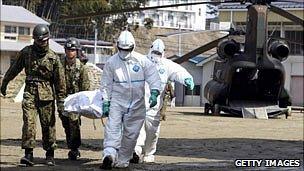 A person is taken by stretcher to a radiation treatment centre in Fukushima prefecture