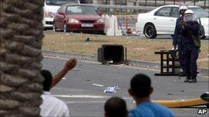 Riot police fire a tear gas canister at anti-government protesters Sunday, March 13, 2011, in Manama, Bahrain