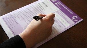 Hand filling in census form