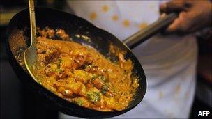 A chef makes an Indian curry