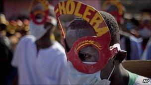 Revellers bearing anti-cholera messages perform during the National Carnival celebrations in Haiti