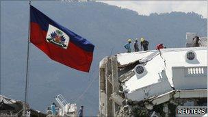 Workers remove debris from the presidential palace, severely damaged in the 2010 quake